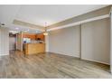 Open-concept living and dining area featuring wood-style flooring and a view into the kitchen at 8255 S Las Vegas Blvd # 1404, Las Vegas, NV 89123