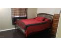 Cozy bedroom features dark wood floors and a large bed with a dark wood frame at 857 Lantham Pl, Las Vegas, NV 89110