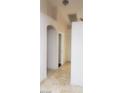 Inviting hallway with neutral tile flooring and archway leading to other rooms at 857 Lantham Pl, Las Vegas, NV 89110