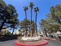 Community entrance features mature trees and landscaping at 8940 Clairton Ct, Las Vegas, NV 89117