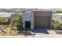 Charming single Gathering home with two-car garage, stone facade, modern stucco, and xeriscaped front yard at 9 Reverie Heights Ave, Henderson, NV 89011
