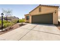 Spacious two-car garage and driveway, with desert landscaping at 9001 Picket Fence Ave, Las Vegas, NV 89143