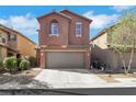 Two-story home with a two-car garage and a concrete driveway at 9335 Tonkawa Ave, Las Vegas, NV 89178