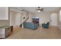 A living room with hardwood floors, neutral-colored walls, and a ceiling fan at 9335 Tonkawa Ave, Las Vegas, NV 89178