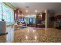 Traditional style kitchen with dark wood cabinets, granite countertops, stainless steel appliances, and view to adjacent room at 9431 S Tee Pee Ln, Las Vegas, NV 89178