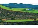 Beautiful golf course with manicured greens and sand traps, set against a backdrop of rolling hills at , Henderson, NV 89012
