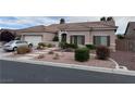 Charming single-story home featuring a well-manicured front yard and a two-car garage at 10023 Liberty View Rd, Las Vegas, NV 89148