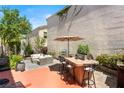 Outdoor kitchen and seating area, perfect for entertaining friends and Gathering in your private backyard space at 10276 Cherry Brook St, Las Vegas, NV 89183