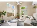 Bright living room featuring vaulted ceilings, large windows, modern furnishings, and stylish decor at 10276 Cherry Brook St, Las Vegas, NV 89183