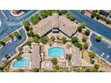 Aerial view of the community pool and recreational facilities, surrounded by lush landscaping at 10631 Kennedy Peak Ln, Las Vegas, NV 89166