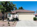 Charming single-story home with a tile roof, well-maintained landscaping, and a spacious driveway at 1121 Majestic Canyon St, Henderson, NV 89052
