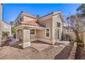 Backyard with brick patio, gravel and walkway featuring a covered area with columns at 1425 Bow Creek Ct, Las Vegas, NV 89128