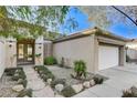 Welcoming front entrance with stone pathway, complemented by manicured landscaping at 1637 Wellington Springs Ave, Henderson, NV 89052