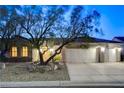 Charming single-story home with a well-manicured yard and a three-car garage, captured at twilight at 1637 Wellington Springs Ave, Henderson, NV 89052