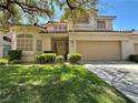 Inviting two-story home showcasing a well-manicured lawn and attached two-car garage at 1753 Tanner Cir, Henderson, NV 89012
