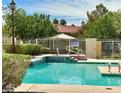 Community pool features a waterfall feature and lounge area, perfect for relaxation at 1753 Tanner Cir, Henderson, NV 89012