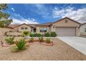 Charming single-story home with manicured low maintenance desert landscaping and brick-lined garden at 2092 Wildwood Lake Street, Henderson, NV 89052