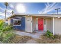 Charming home featuring a bright red front door and desert landscaping at 2129 N Michael Way, Las Vegas, NV 89108