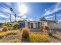 Ranch-style house featuring a red front door and desert landscaping at 2129 N Michael Way, Las Vegas, NV 89108