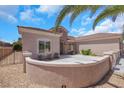 Inviting front exterior with stucco walls, desert landscaping, and a spacious driveway, perfect for curb appeal at 2349 Orangeburg Pl, Henderson, NV 89044