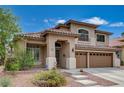 Charming two-story home featuring a tile roof, desert landscaping, and a three-car garage at 3055 Whispering Crest Dr, Henderson, NV 89052