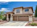 Inviting two-story home featuring a tile roof, three-car garage, and low-maintenance landscaping at 3055 Whispering Crest Dr, Henderson, NV 89052