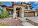 Charming two-story home featuring a tile roof, desert landscaping, and a three-car garage at 3055 Whispering Crest Dr, Henderson, NV 89052