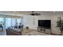 Open living area with a dining area, modern lighting, and neutral decor, with view to the backyard at 314 W Winston Ln, Indian Springs, NV 89018