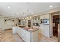 Spacious gourmet kitchen with large island, pendant lighting, and ample storage space at 3141 E Katie Ave, Las Vegas, NV 89121