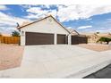 Inviting single-story home with a two-car garage, showcasing a well-kept driveway and desert landscaping at 3630 Daisy Field Dr, North Las Vegas, NV 89032