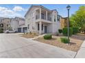 Two-story home featuring a balcony, neutral-toned exterior, manicured landscaping, and a welcoming entrance at 4517 Lime Straight Dr, Las Vegas, NV 89115