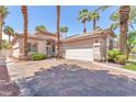 Lovely single story home with a brick driveway, desert landscaping, and a two car garage at 465 Indigo Springs St, Henderson, NV 89014