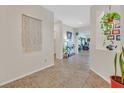 Light-filled entryway with tile flooring, decorative wall art, and bright neutral paint at 5226 Lignum Ave # 1, Pahrump, NV 89061
