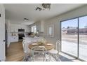 Bright dining area features a round table, stylish chandelier, and sliding glass door to the backyard at 5273 Manassas Ave, Las Vegas, NV 89122