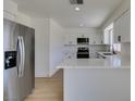 Bright kitchen with white cabinets, stainless steel appliances, and an eat-in countertop at 5273 Manassas Ave, Las Vegas, NV 89122