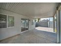 Covered patio features a concrete floor and string lights, offering a comfortable outdoor space for relaxation at 544 Rancho Del Sol Way, North Las Vegas, NV 89031