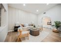 Bright living room with a neutral color palette, comfortable seating, and an arched doorway to other spaces at 5840 N El Capitan Way, Las Vegas, NV 89149