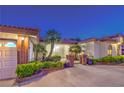 Welcoming front exterior with manicured landscaping, brick accents, and gated entry; perfect curb appeal at 7521 Dry Pines Cir, Las Vegas, NV 89129