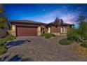 Lovely single-story home featuring a brick driveway and desert landscaping at 775 Porto Mio Way, Las Vegas, NV 89138