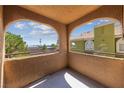 Arched balcony overlooking a green residential area with clear skies, offering a serene outdoor space at 7950 W Flamingo Rd # 2066, Las Vegas, NV 89147