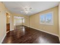 Bright bedroom with wood floors, ceiling fan, large window with blinds, and mirrored closet doors at 7950 W Flamingo Rd # 2066, Las Vegas, NV 89147