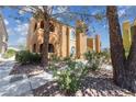 A charming two-story building with arched balconies, set among lush landscaping and mature trees at 7950 W Flamingo Rd # 2066, Las Vegas, NV 89147