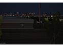 A cityscape view at night featuring building lights and a Ferris wheel at 7950 W Flamingo Rd # 2066, Las Vegas, NV 89147