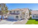 Charming stucco home featuring a red tile roof, arched entryway, and a spacious two-car garage at 8753 Fountain Island Dr, Las Vegas, NV 89147