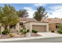 Inviting single-story home with desert landscaping, two-car garage, and tile roof at 9437 January Dr, Las Vegas, NV 89134