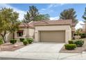 Inviting single-story home with desert landscaping, two-car garage, and tile roof at 9437 January Dr, Las Vegas, NV 89134