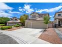 Well-kept home with a three-car garage, landscaped front yard, and a neatly paved driveway at 955 Leadville Meadows Dr, Henderson, NV 89052