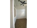 Clean bedroom showcasing a ceiling fan, tiled flooring, and bright neutral walls at 9839 Brook Canyon Dr, Las Vegas, NV 89147