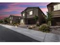 Charming two-story home with a two-car garage during dusk in a well-maintained neighborhood at , North Las Vegas, NV 89031