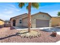 Lovely single-story home featuring desert landscaping, a two-car garage and a cozy entryway at 1024 Fishing St, Henderson, NV 89011